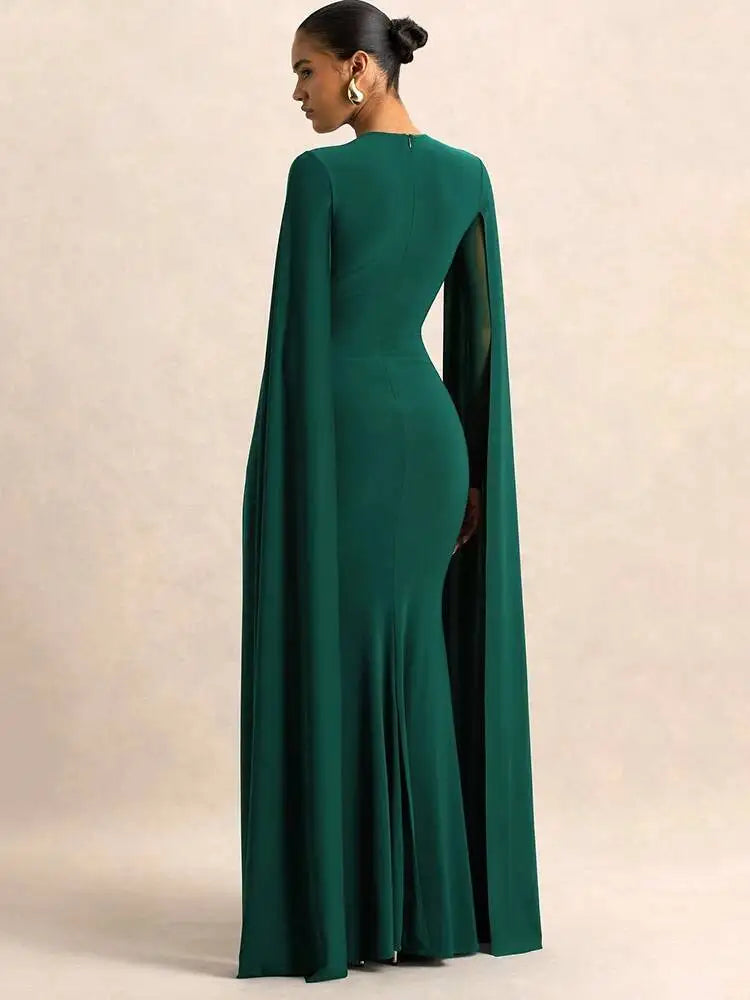Green evening gown with cape on a beige background