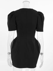 Black dress on a mannequin with a clear stand against a white background