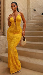 Woman in a yellow dress standing on stone steps