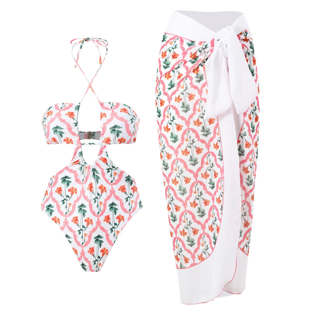White floral printed one-piece swimsuit and matching sarong skirt.