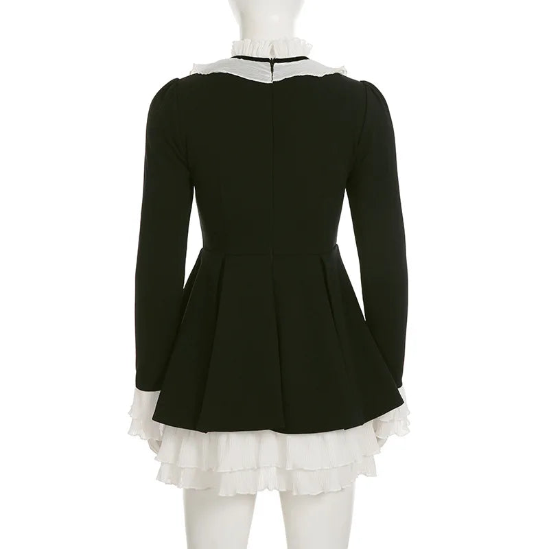 Black dress with white ruffled collar and hem on a mannequin against a white background