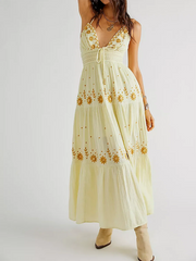 Light yellow dress with floral embroidery on a white background