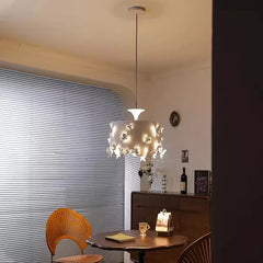 Modern interior with a chandelier, table, and chair against a striped wall.