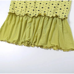Yellow dress with ruffled skirt on a white background