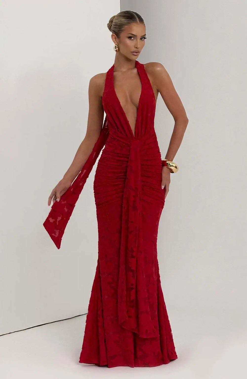 Woman wearing a red evening gown against a white background