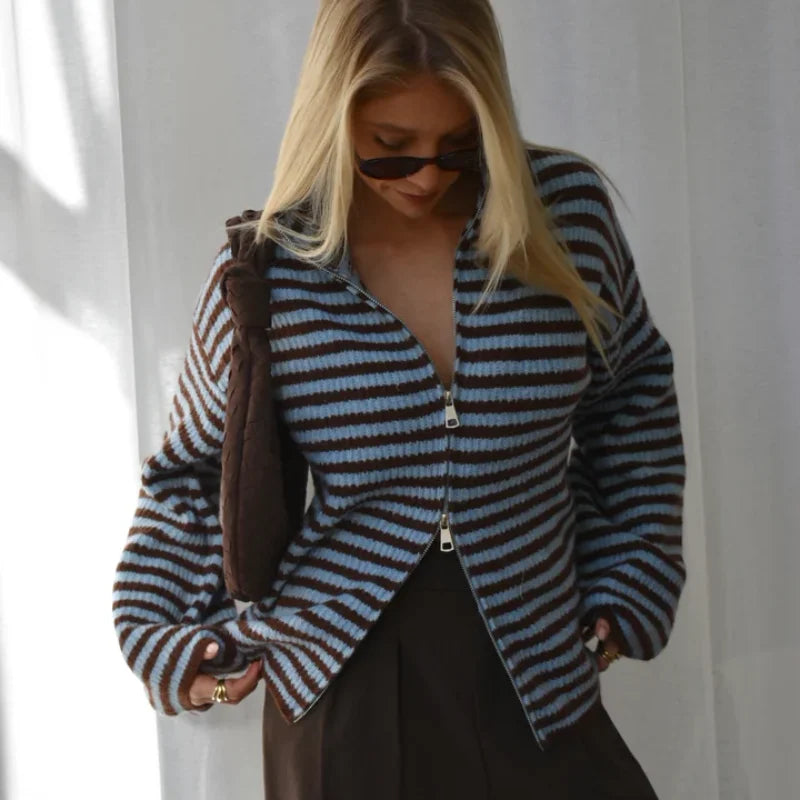 Styled shot of striped knit sweater with zipper open