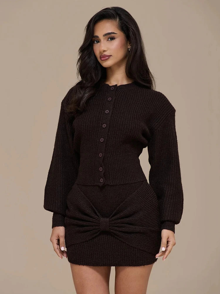 Woman wearing a brown ribbed knit outfit with a bow detail on a beige background