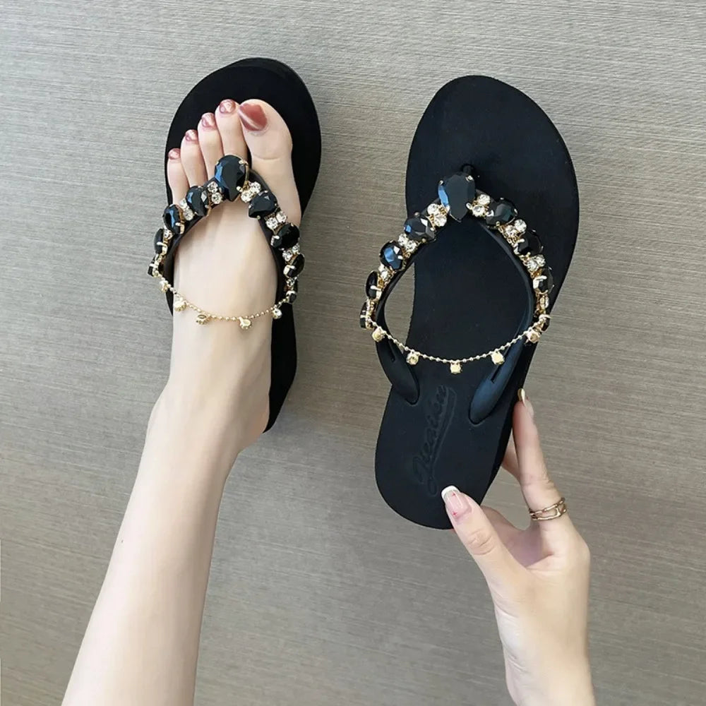 Black embellished wedge flip flops with black faceted stones