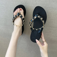 Black embellished wedge flip flops with black faceted stones