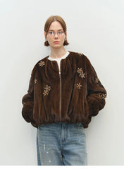 Model wearing brown faux fur bomber jacket with light wash jeans
