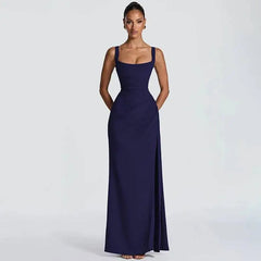 Woman wearing a navy blue evening gown on a light gray background