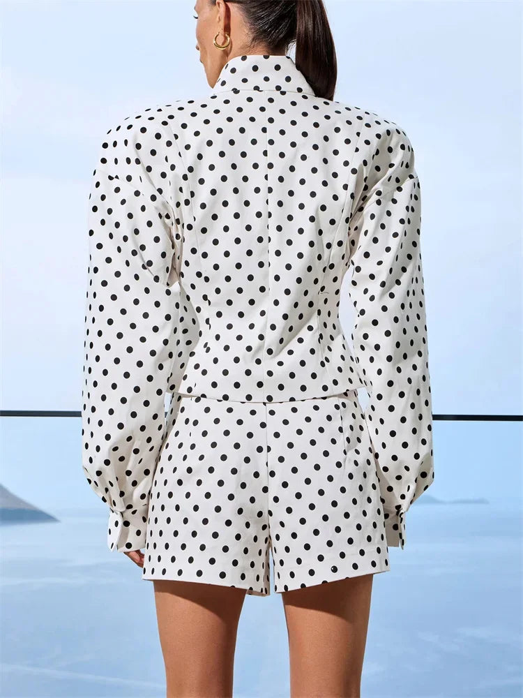 Person wearing a polka dot outfit with a blurred background