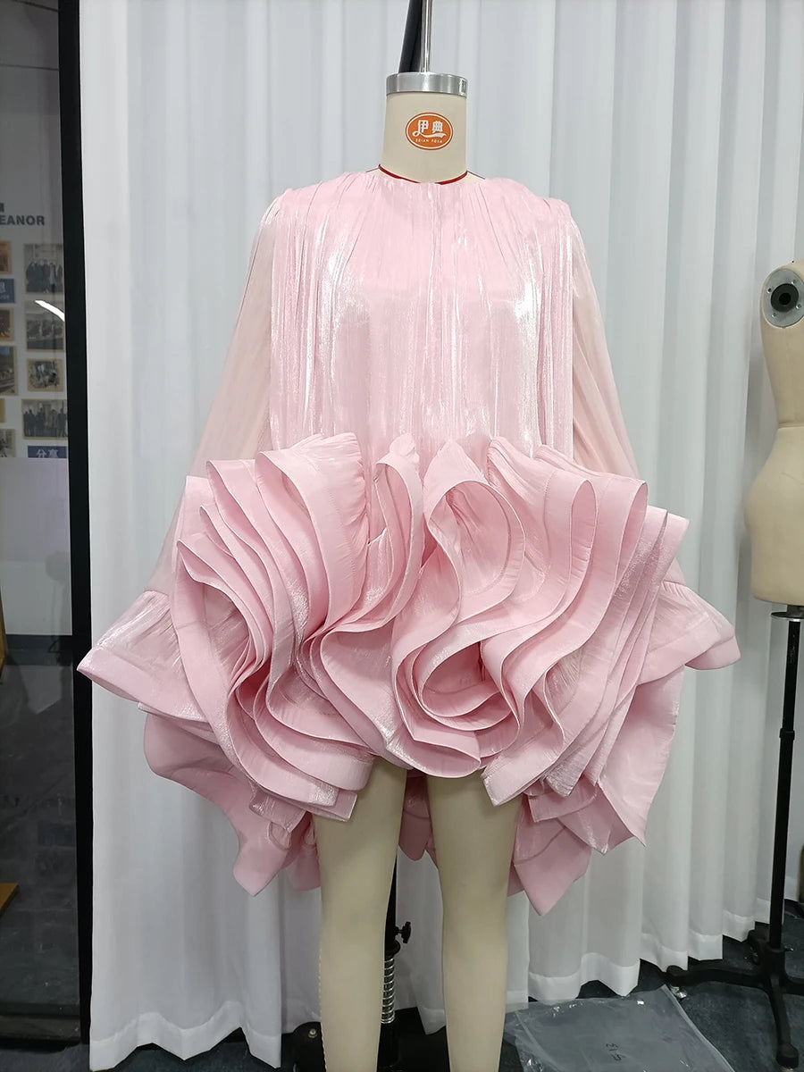 Mannequin displaying a pink ruffled organza mini dress with bell sleeves in a studio setting.