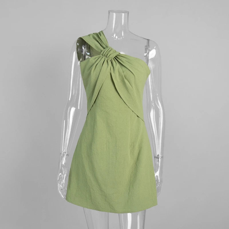 Green dress on a transparent mannequin against a gray background