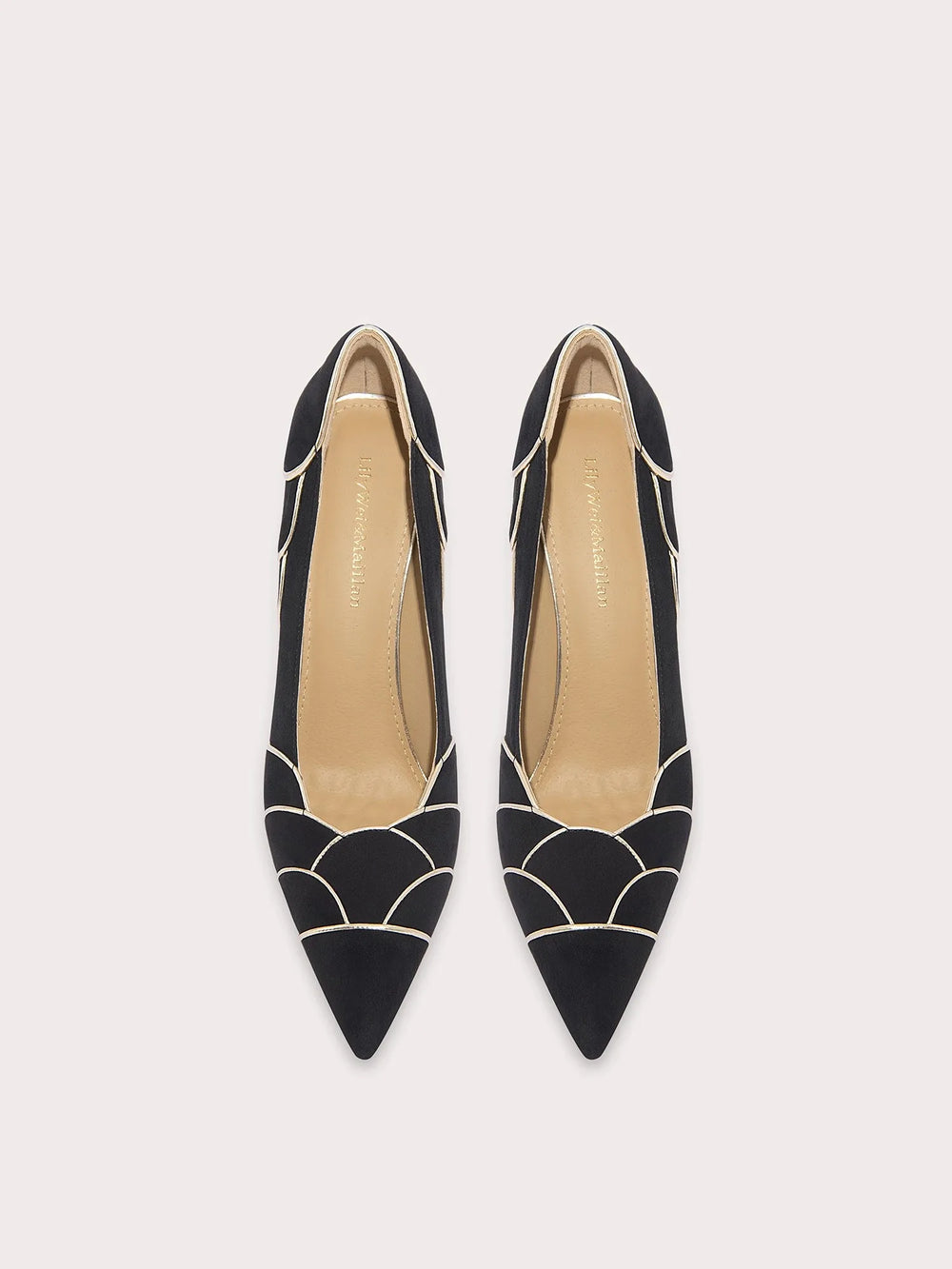 Black pointed-toe shoes with geometric design on a white background