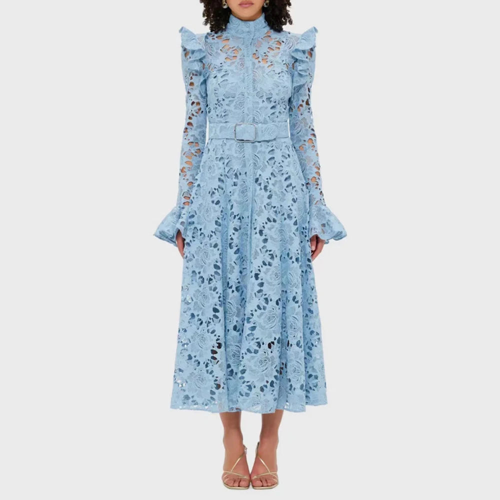 Woman wearing a light blue floral dress on a white background