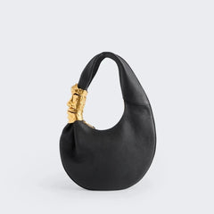 Black grained leather half moon shoulder bag with sculpted gold face hardware detail, front view