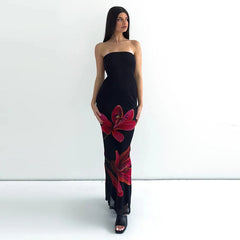  A woman wearing a black floral tube maxi dress with a tie-back detail, showcasing its elegant design.  Golden Atelier 3