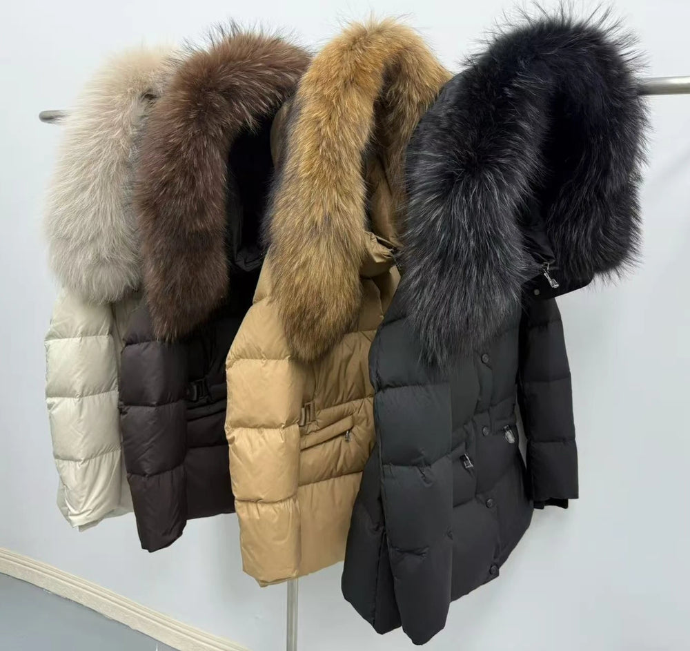 Four puffer jackets with fur hoods in different colors on a rack.