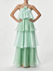 Halter neck tiered maxi dress with hands on hips