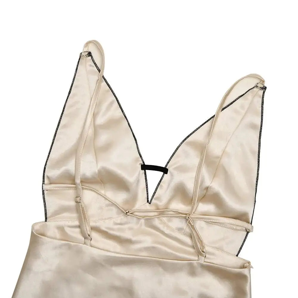 Beige satin dress with thin straps on a white background