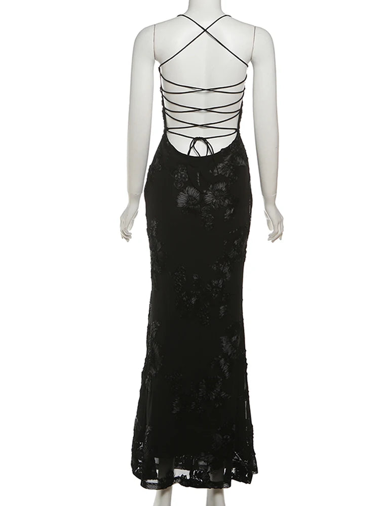 Black lace evening gown on a mannequin against a white background