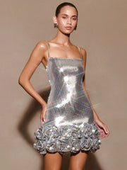 Model wearing a silver sequin dress with a beige background