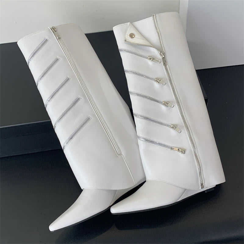 White knee-high boots with zippers on a black surface