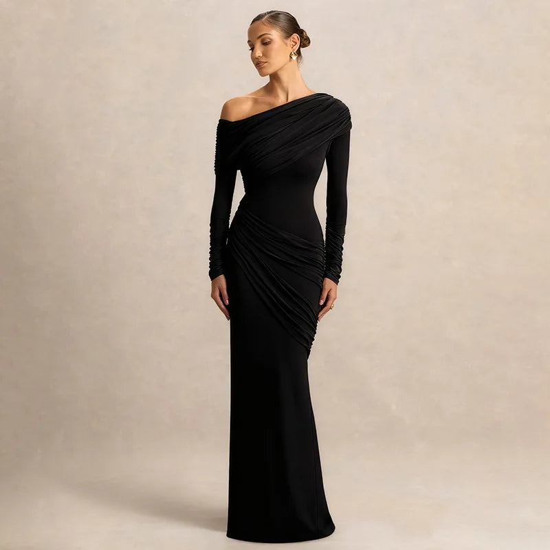 Woman wearing a black one-shoulder dress against a beige background