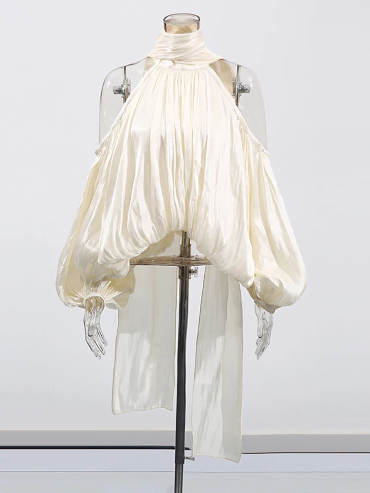 White blouse with puffed sleeves on a mannequin against a white background