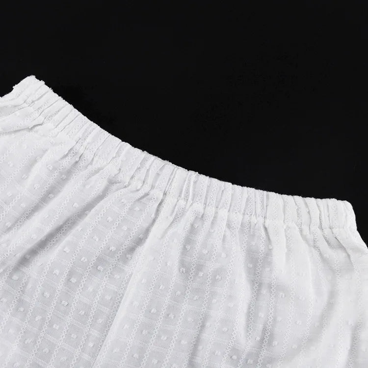 Close-up of white textured fabric against a black background
