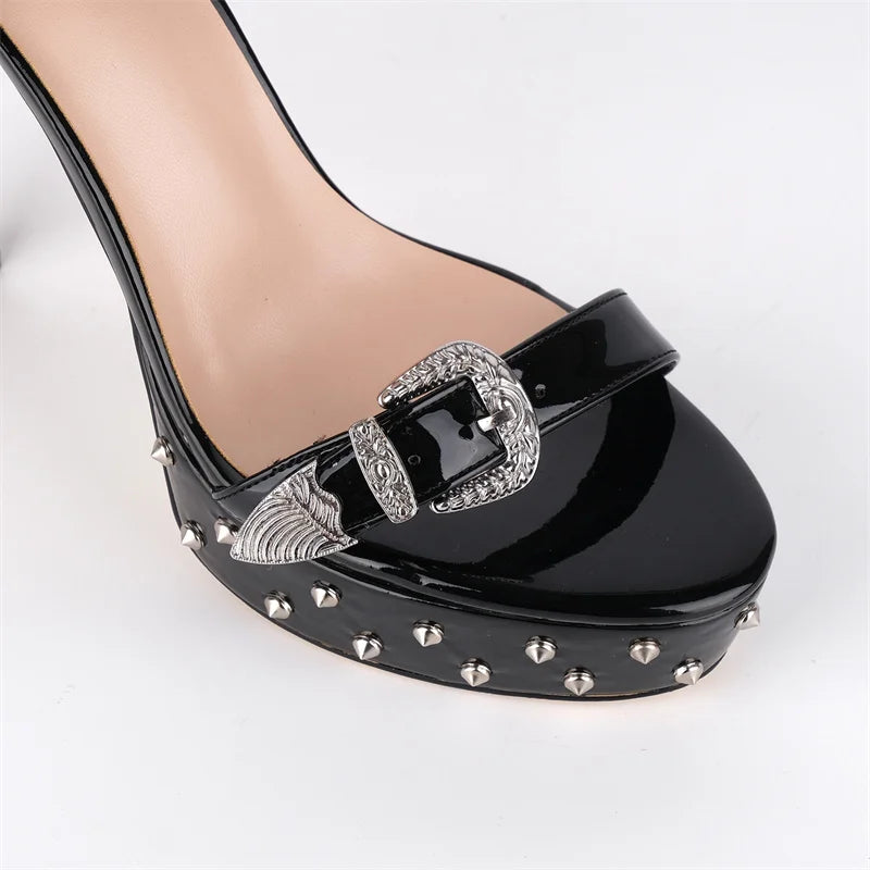 Black high-heeled shoe with decorative buckle and studs on a white background