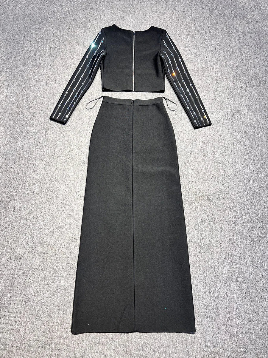 Black outfit with long sleeves and a high-waisted skirt on a gray background