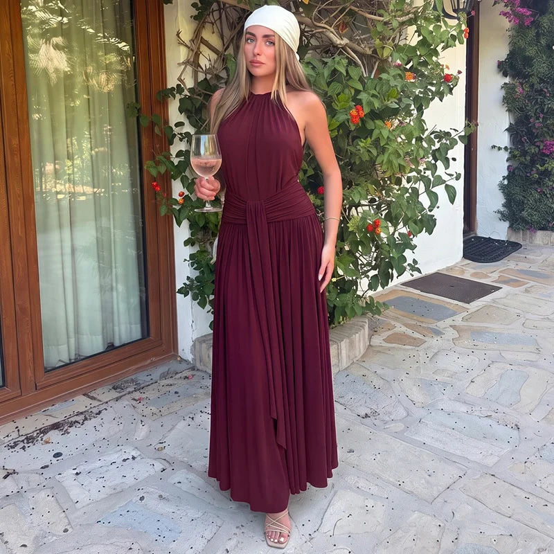 Woman wearing a halter neck draped maxi dress outdoors