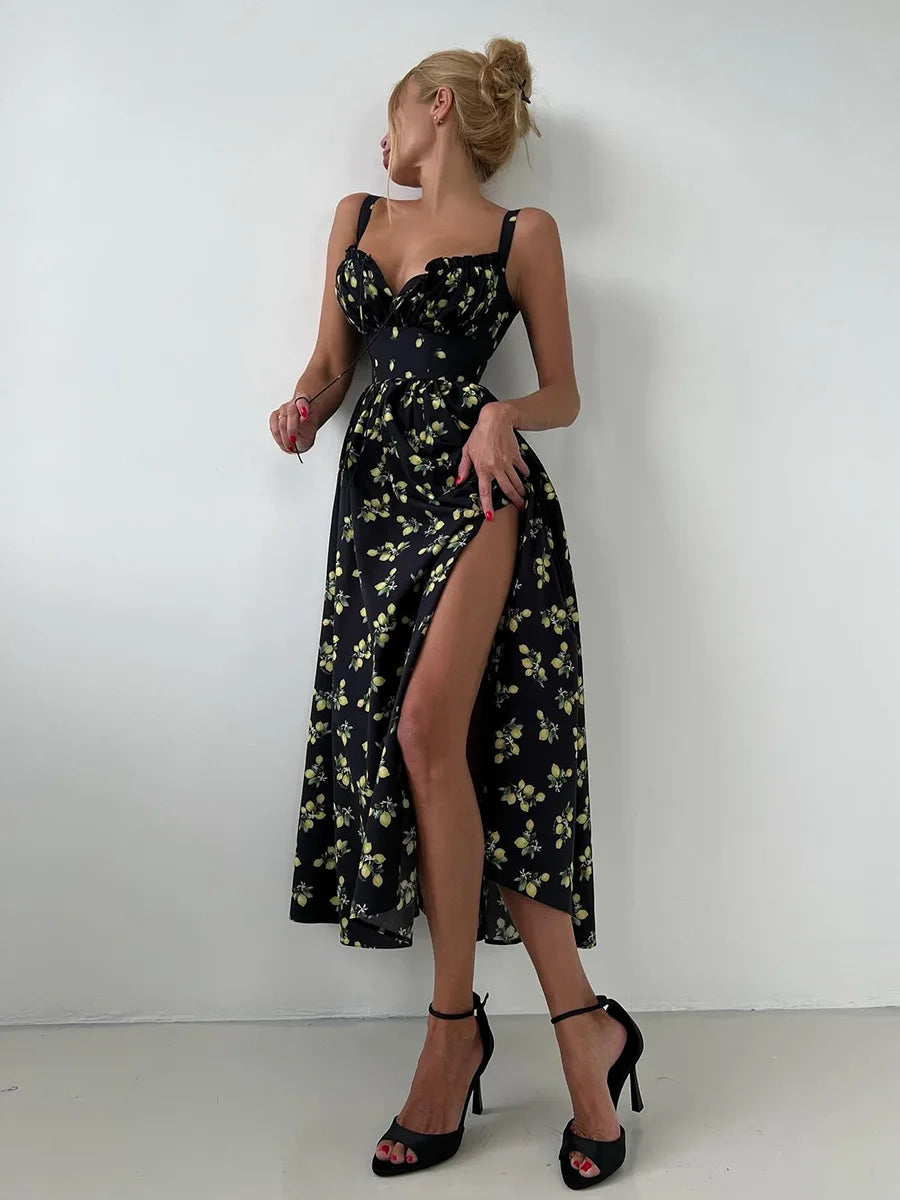 Woman wearing a black floral dress with a high slit on a white background