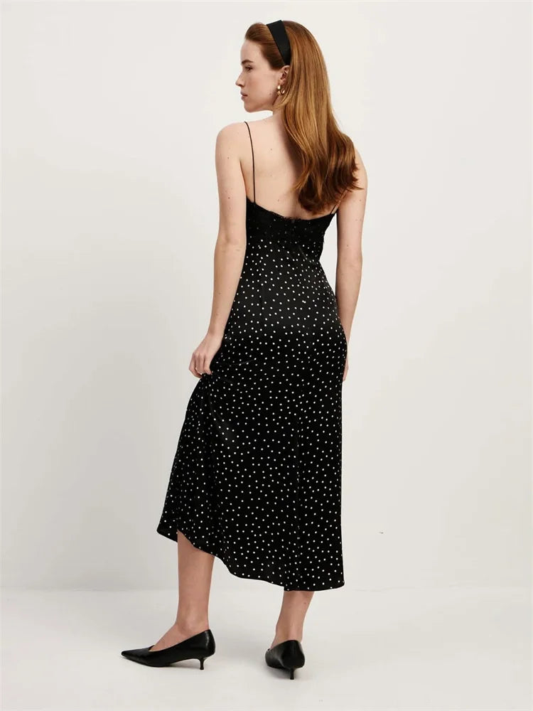 Woman wearing a black polka dot dress on a white background
