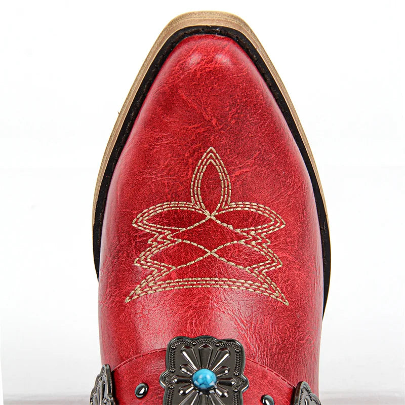 Close-up of the pointed toe on red western ankle boots with embroidery