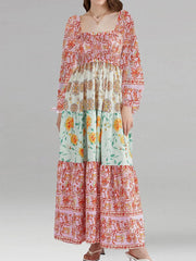Long, floral-patterned dress on a plain background