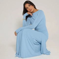 Woman wearing a light blue dress against a plain background