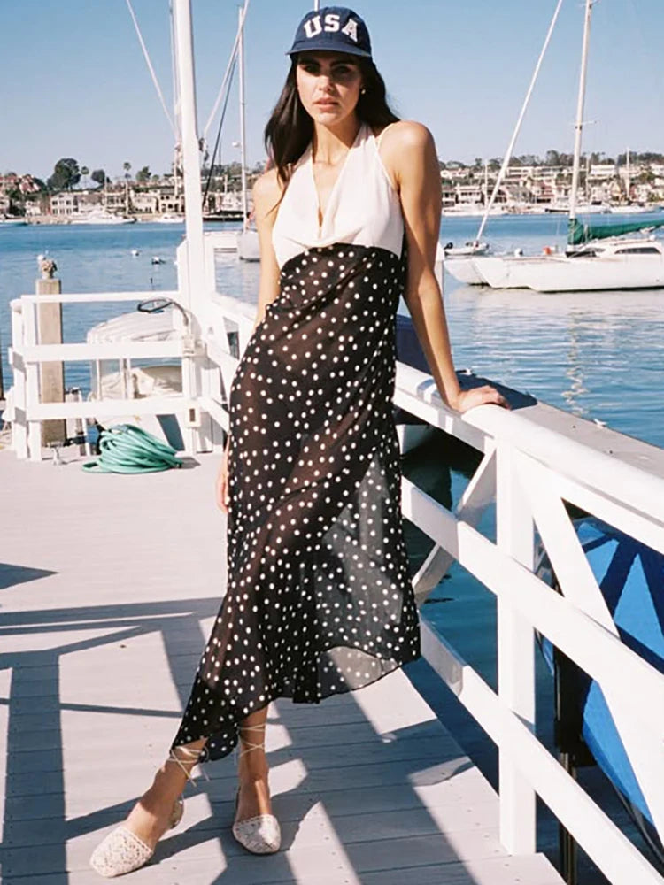 Full body shot of a contrast panel polka dot maxi dress.