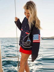 Side view of navy blue intarsia knit coat with sailboat pattern