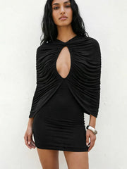 Model wearing black draped cutout mini dress with bracelet