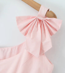 Pink dress with a large bow on a white background