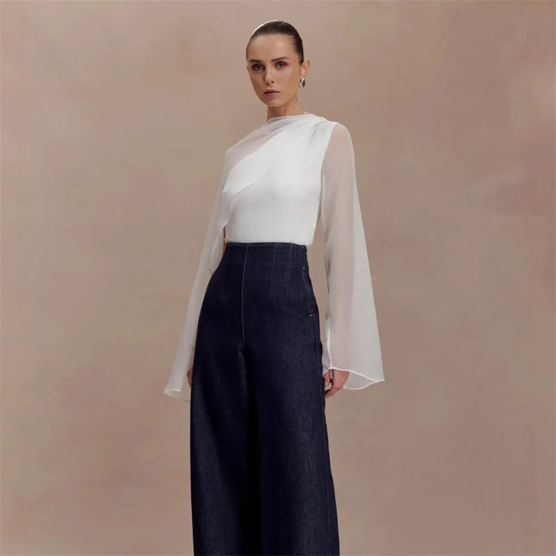 Asymmetrical draped cape sleeve blouse with sheer overlay standing pose