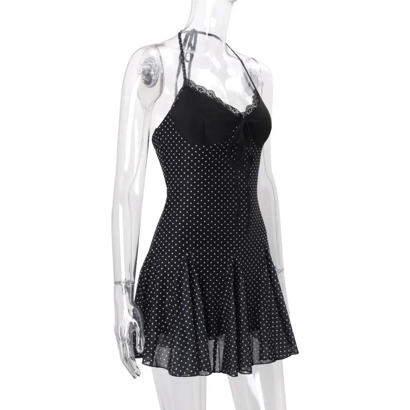 Black polka dot dress on a mannequin against a white background