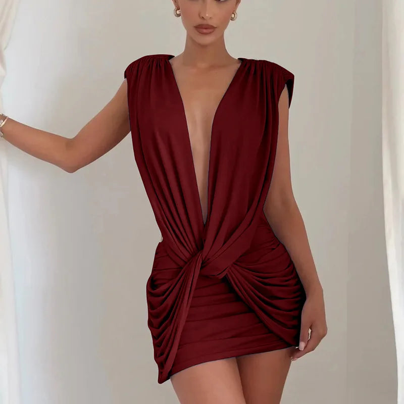 Red dress with a deep neckline and draped design on a plain background