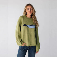 Model wearing green crew neck knit sweater with fish graphic print