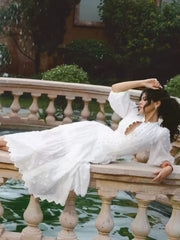 White embroidered puff sleeve midi dress lying down