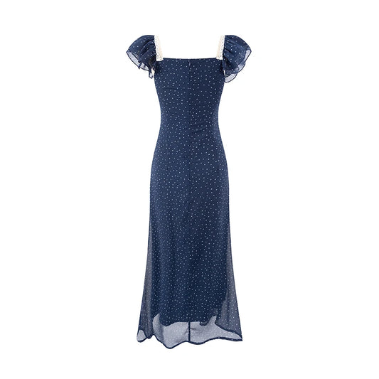 Back view of a blue polka dot midi dress with a square neckline and ruffled sleeves.