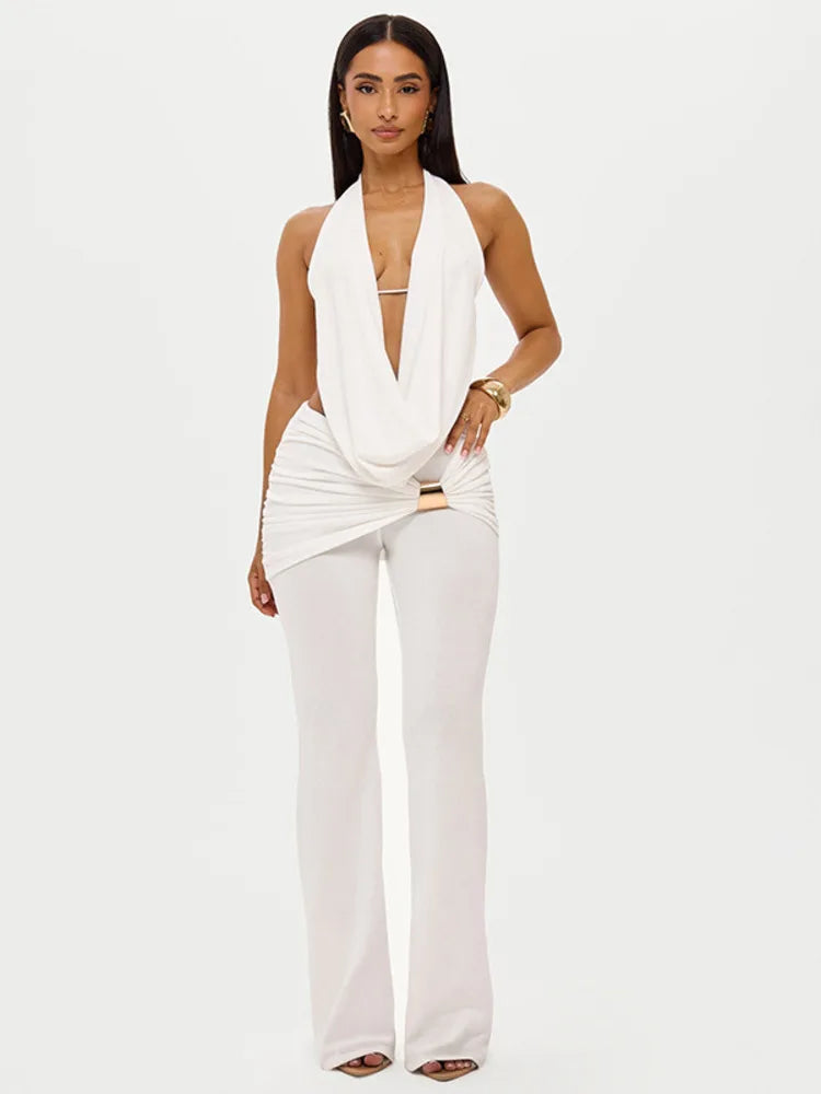 Woman wearing a white outfit with a draped top on a white background